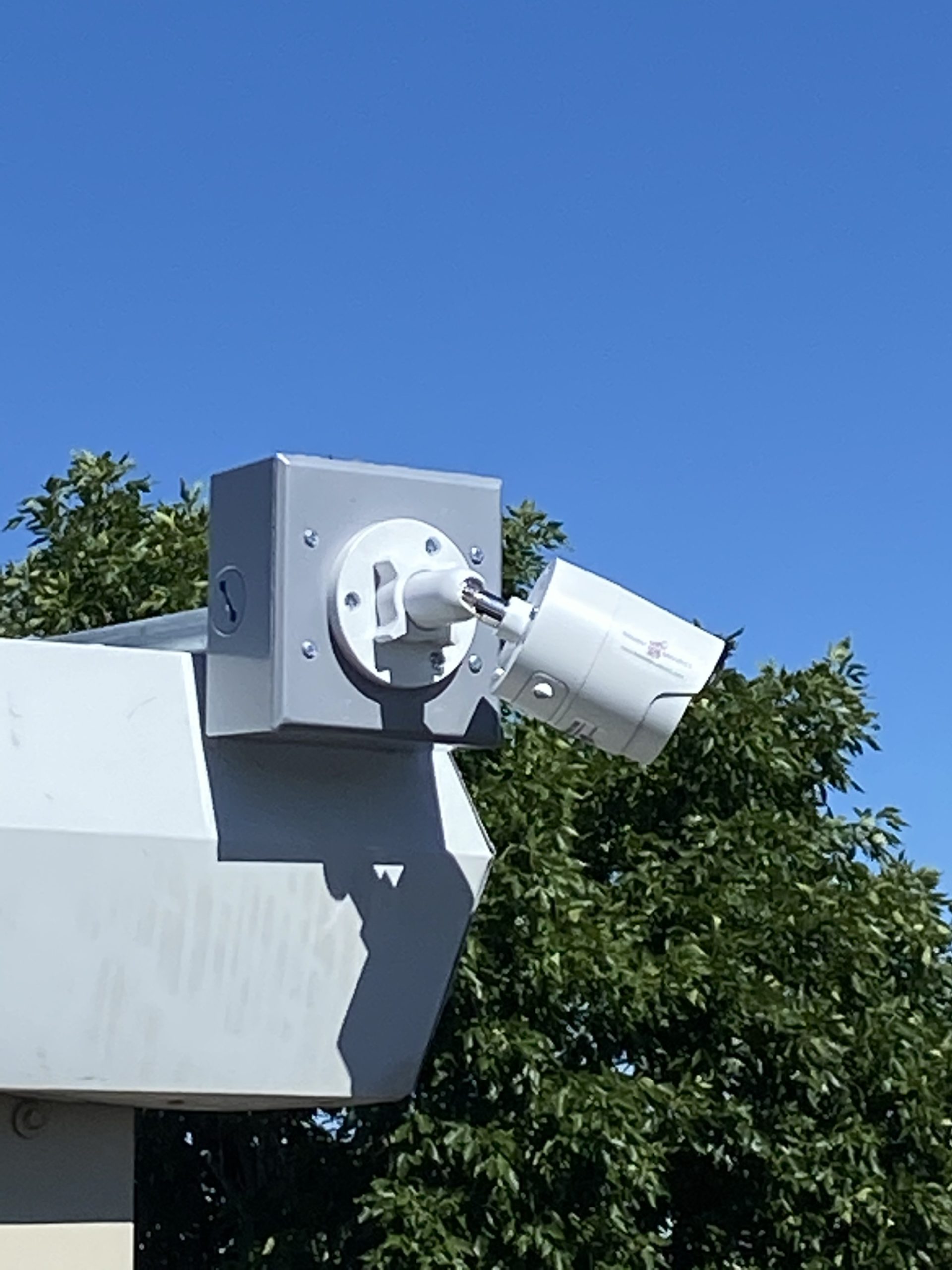 Bullet security camera mounted on the corner of a roof